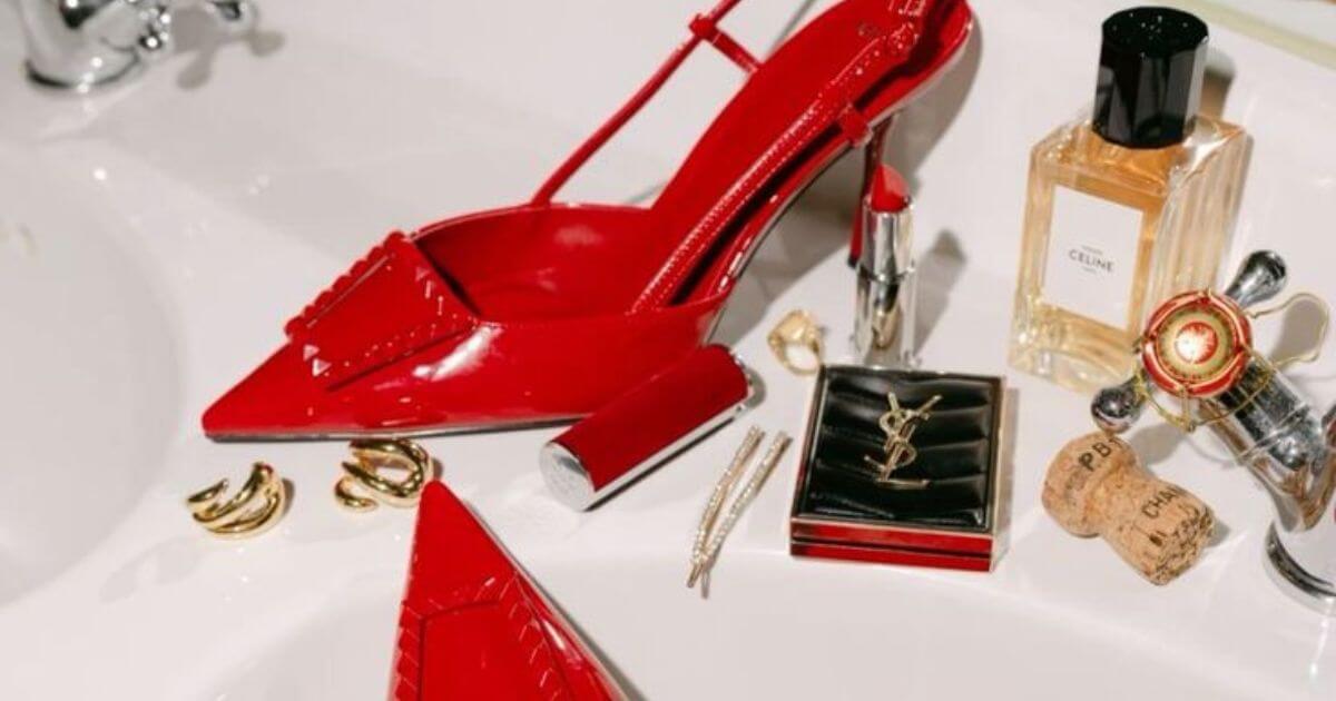 Femme fatale accessories flat lay with gold and dark tones