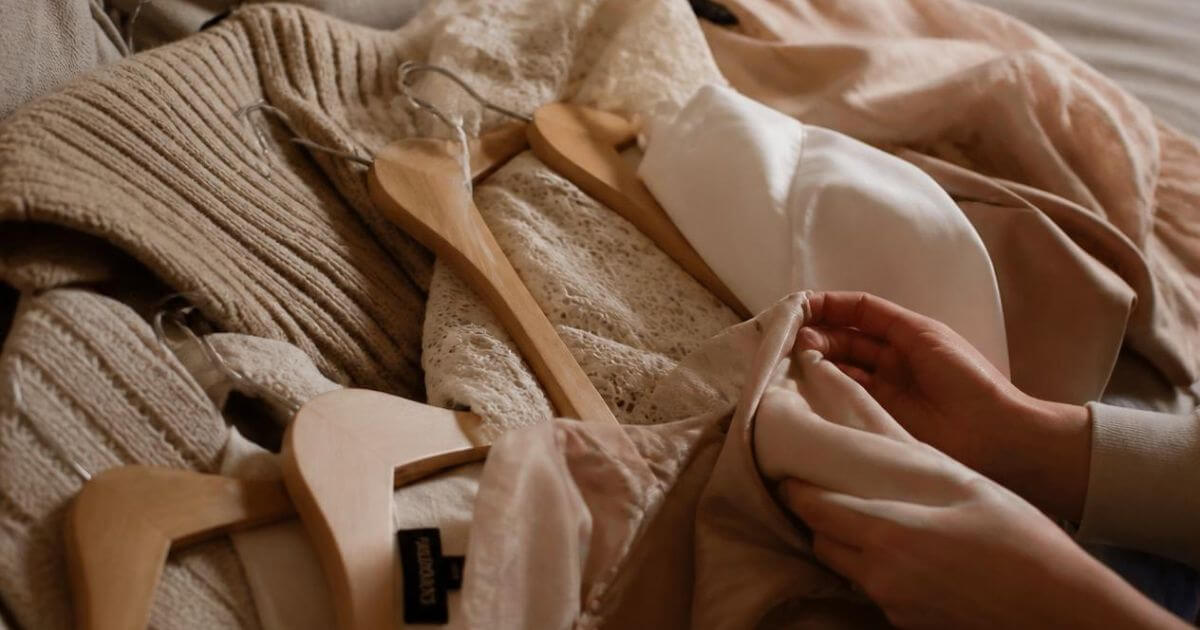 Pile of clothes being sorted and decluttered on a couch